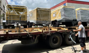 Multiple XAS186 trucks are being loaded and shipped to the port